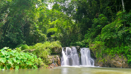 Beautiful scenery of waterfall surrounded by lush foliage vegetation in rainforest. Ton Yai Waterfall, Surat Thani Province, Thailand. Wonderful tropical wild nature.