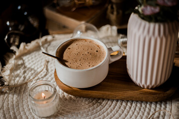 mocha coffee in white cup with foam, golden spoon, morning coffee in sunlight, autumn leaves, pink asters, autumn flowers, breakfast, candles
