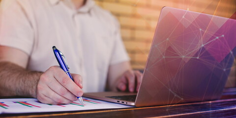 online work from home. A man plans a daily meeting and records a business trip on a laptop at his desk. Event planning concept with calendar reminder.