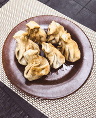 Fried khinkali in a plate on the table
