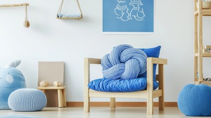 Pillow on blue chair in kid's playroom with blue furniture.