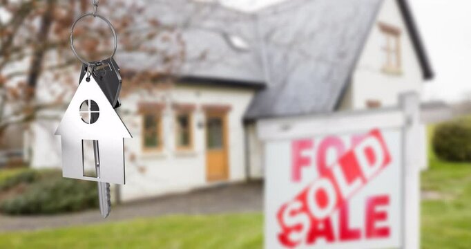 House keychain and key animation over sold sign in front of house