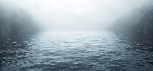 A misty, foggy scene over a body of water. The mist obscures the view, creating an atmospheric and ethereal landscape.