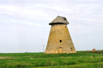Fototapeta premium an old broken down windmill on the meadow