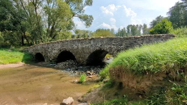 A historical and scenic old medieval stone bridge Most U Lutriana by Havlickuv Brod in Vysocina region offers a picturesque view and a glimpse into traditional Czech architectural beauty and heritage