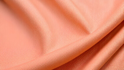 Peach-colored fabric with a textured, woven pattern