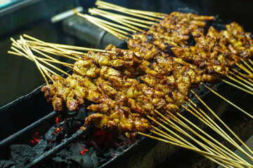Grilling Traditional Indonesian Satay Skewers Over Charcoal