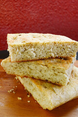 Stack of Delicious Rosemary Focaccia Bread Slices on Wooden Breadboard