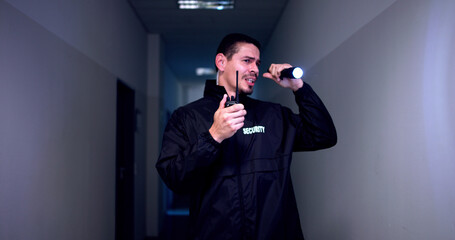 Male Security Guard With Flashlight