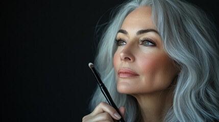 Obraz premium Embracing Age Positivity: Silver-Haired Beauty Influencer Applying Makeup Live Tutorial
