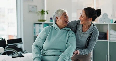 Happy woman, physiotherapist and physical therapy with dumbbells for exercise or therapeutic technique at clinic. Female person, therapist and senior patient weightlifting for muscle recovery session