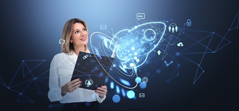 Businesswoman with clipboard, glowing hologram of rocket with business icons