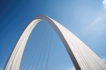 Obraz premium Majestic Modern Arch Bridge Against Blue Sky