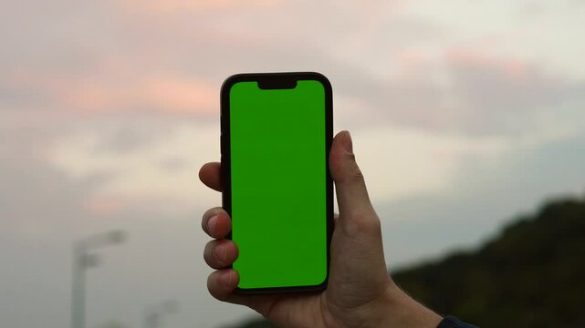Green screen on smartphone to replace the background.
Chrome key on the phone.
Green screen against sunset background.
Smartton and the evening sky.
Chrome key, smartphone, sky, clouds, green