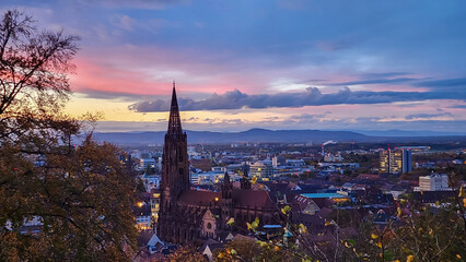 Fototapeta premium The landscape view of autumn trees historic buildings at the famous old town of Freiburg im Breisgau ,Germany