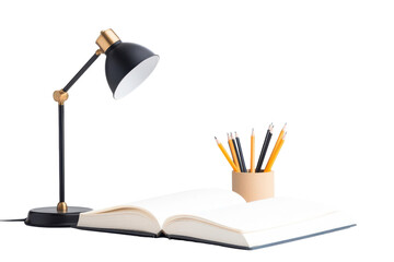 A creative workspace featuring an open book, a desk lamp, and a holder filled with colorful pencils.