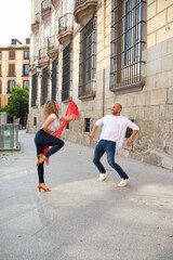 Man and woman dancing cuban salsa in the street on a sunny day