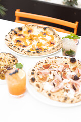 Pizzas on a plates with drinks