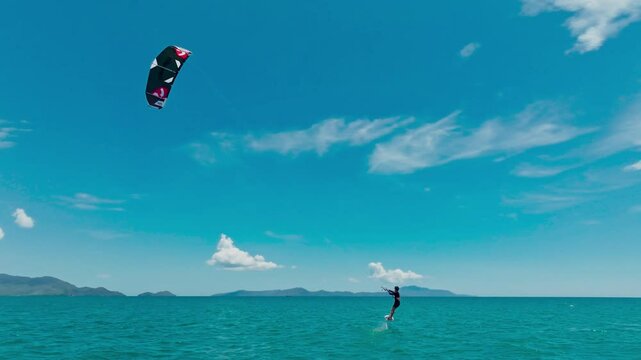 Kitesurfing in the ocean on a sunny day