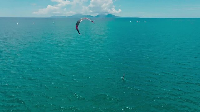 Kitesurfing in the ocean on a sunny day