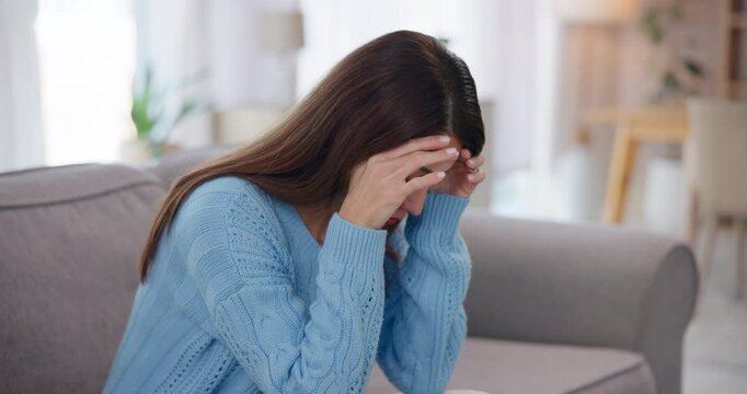 Home, stress and woman with headache, pain and dizzy in living room with burnout. Apartment, person and girl on sofa, migraine and pressure with muscle tension, crisis and brain fog with anxiety