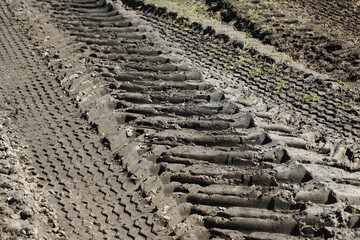 Sand tyre mark background. Tire track shape. Trail lines on dry brown sand pattern. Road construction site backdrop. Heavy machinery imprint. Dried mud vehicle wheel shape.