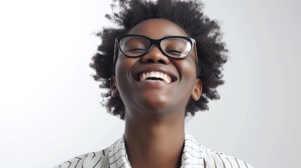 Fototapeta premium A woman with curly hair is smiling and wearing glasses. She looks happy and content. Concept of warmth and positivity