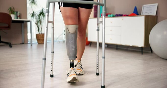 Feet, walker and physiotherapy with prosthetic leg as amputee at wellness center for training or exercise. Person with a disability, patient and support at rehabilitation clinic for muscle or balance