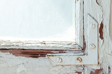 old grunge decayed window frame work elements of wood and metallic screws with scratched glass background ugly view