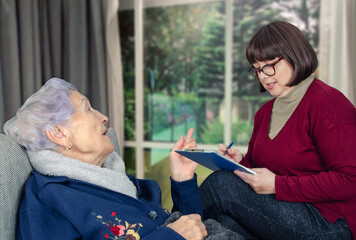 Nurturing Elder Well-being: Candid Moment Shows Social Worker's Vital Role in Amplifying Seniors' Voices and Needs.