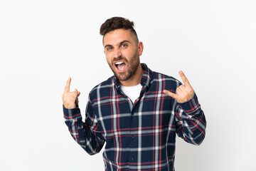 Caucasian man isolated on white background making horn gesture