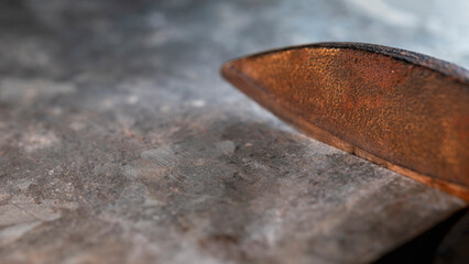 Metal shears cut a sheet of thin galvanized steel.