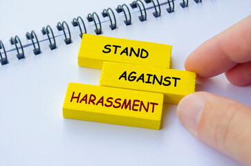 Stand Against Harassment text on yellow wooden blocks. No to Harassment concept