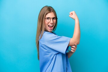 Young surgeon doctor woman isolated on blue background doing strong gesture
