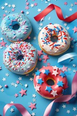 Four donuts with sprinkles and stars on them are arranged on a blue background. The donuts are decorated with red, white, and blue sprinkles and stars, giving them a festive and celebratory appearance