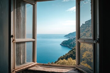 A window overlooking the ocean with a view of the shore. The ocean is calm and the sky is clear
