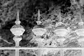old metal fence in black and white film negative