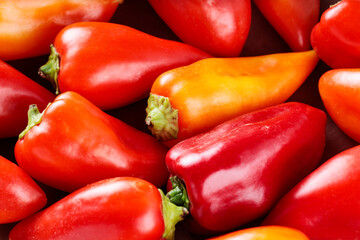 Colorful Bell Peppers Scattered on Rustic Brown Background, Top View