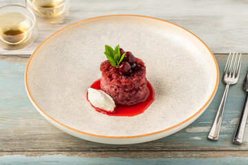 Cherry bread kadayif (ekmek kadayifi) with buffalo clotted cream on wooden table