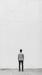 Fototapeta premium 31. A person standing in front of a blank wall