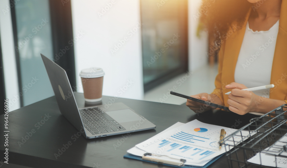 Wall mural close up business woman using calculator and laptop for do math finance on wooden desk, tax, account