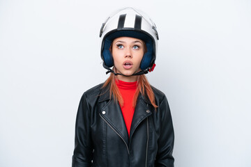 Young Russian girl with a motorcycle helmet isolated on white background looking up and with surprised expression