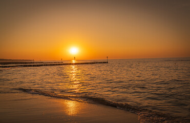 Serene sunset at the shoreline in Kolobrzeg, Kołobrzeg