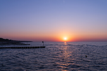 Serene sunset at the shoreline in Kolobrzeg, Kołobrzeg