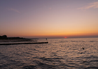 Serene sunset at the shoreline in Kolobrzeg, Kołobrzeg