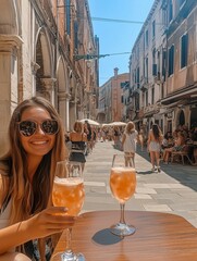 A young tourist girl wearing sunglasses and smiling, drinking a glass of Aperol Spritz.