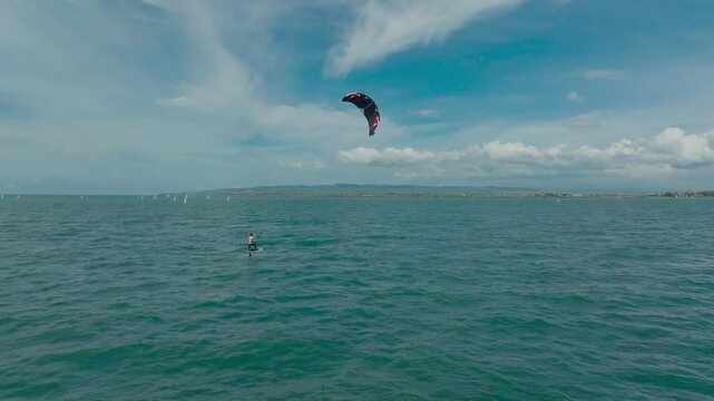 Kitesurfing in the ocean on a sunny day