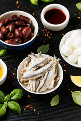 Assortment of marinated anchovies, olives and mini mozzarella cheese. Healthy snacks