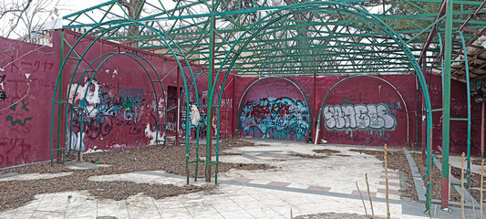 An abandoned site with graffiti on the wall