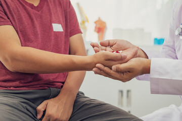 A male doctor examines a patient for an enlarged prostate, a common issue in male sexual health....